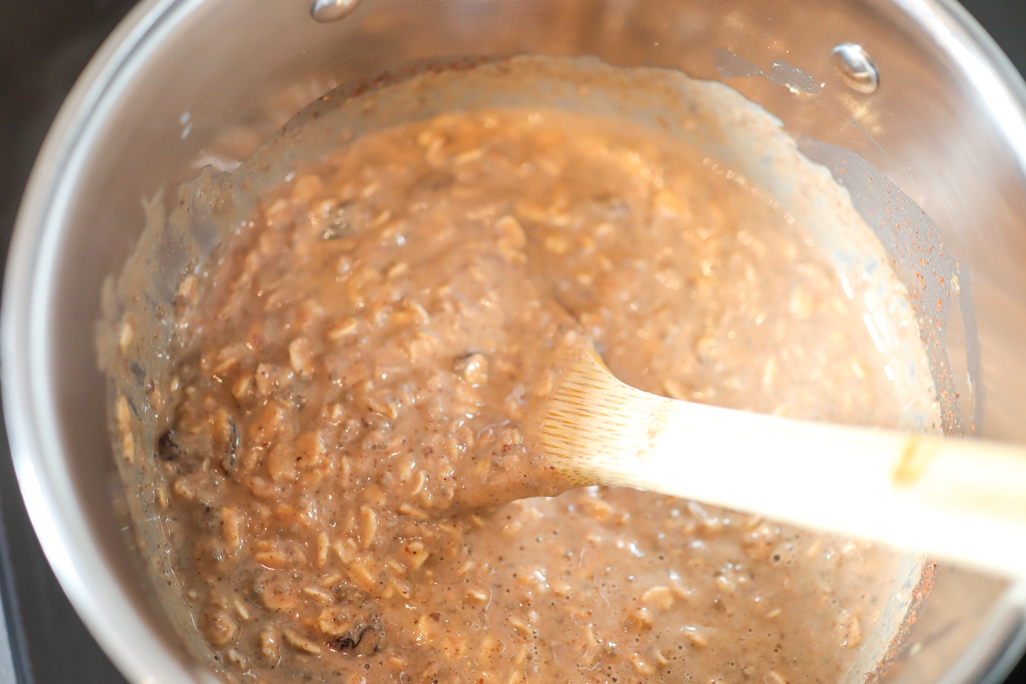 spoon stirring oatmeal in a pot