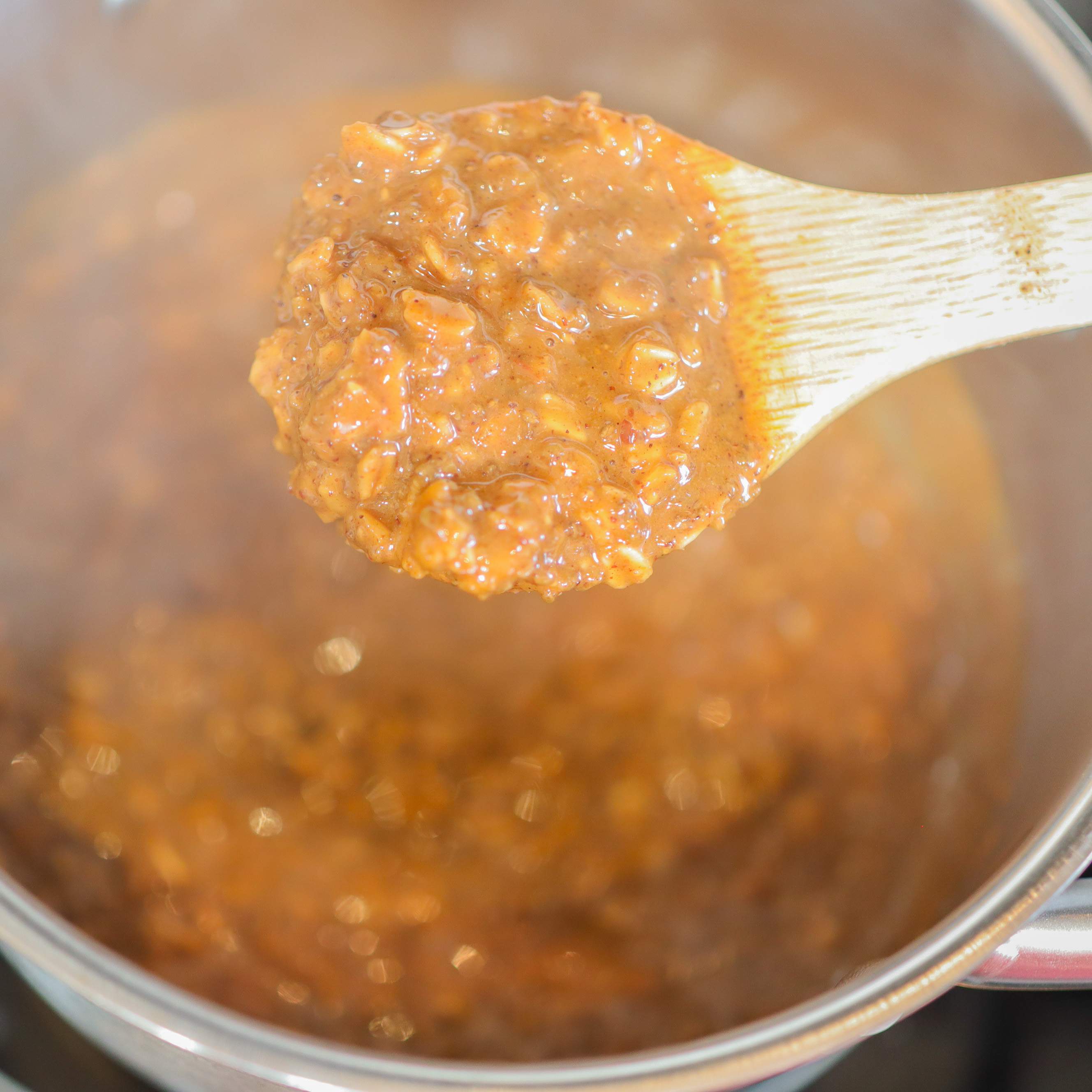 wooden spoon with gingerbread oatmeal in a pot