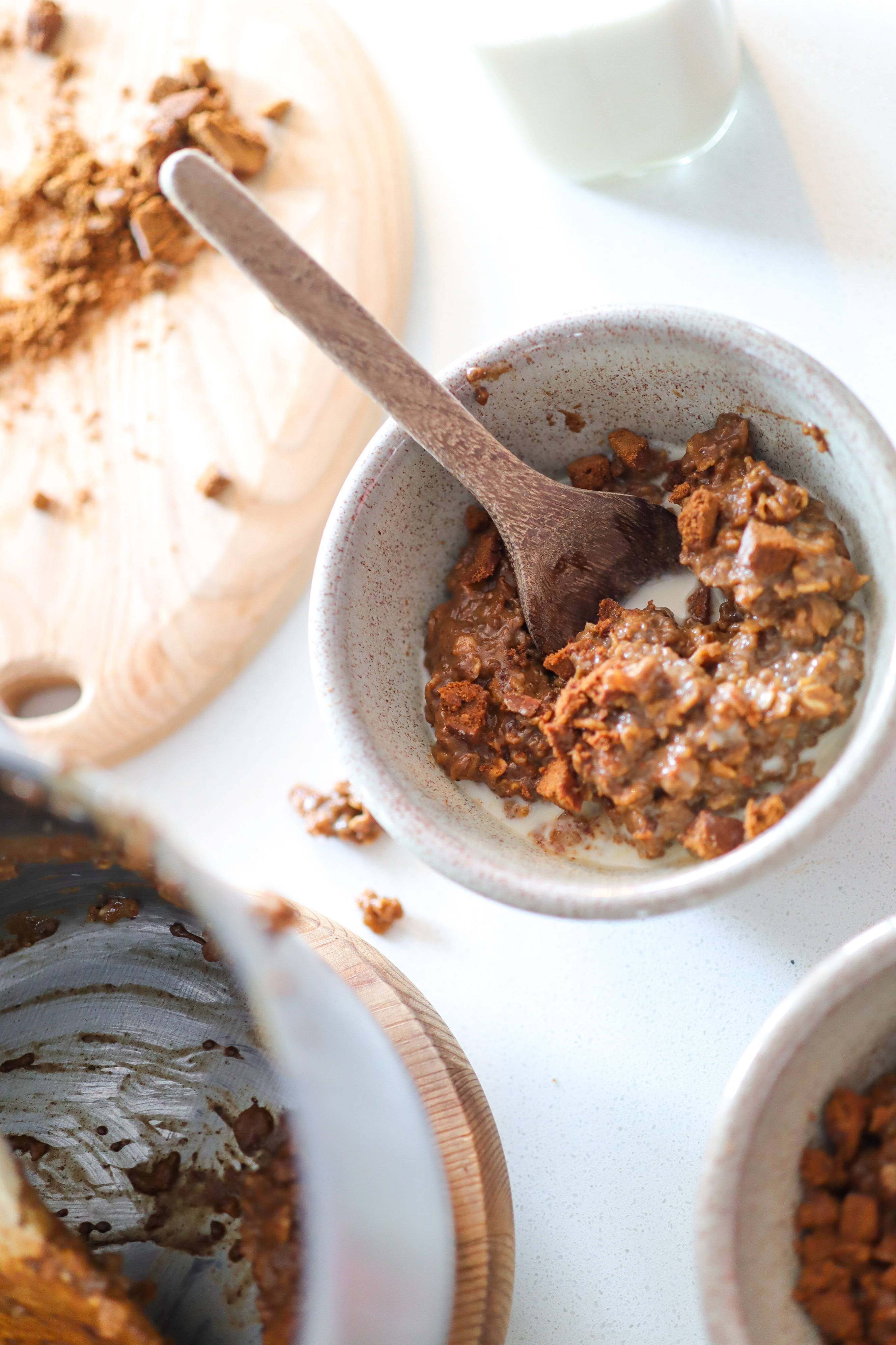 pot and bowl of oatmeal with wooden spoon in it