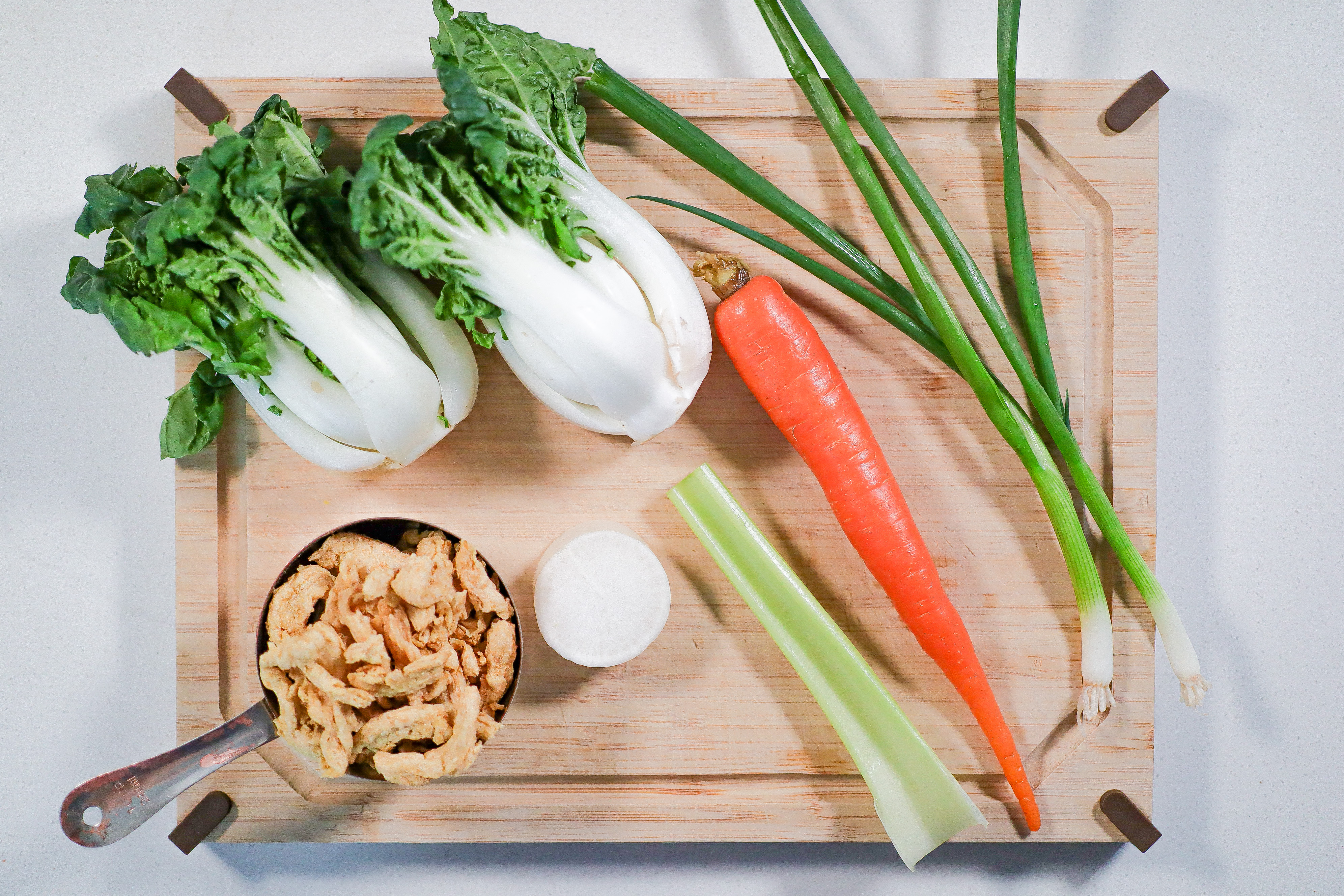 A cutting board with vegetable on top.