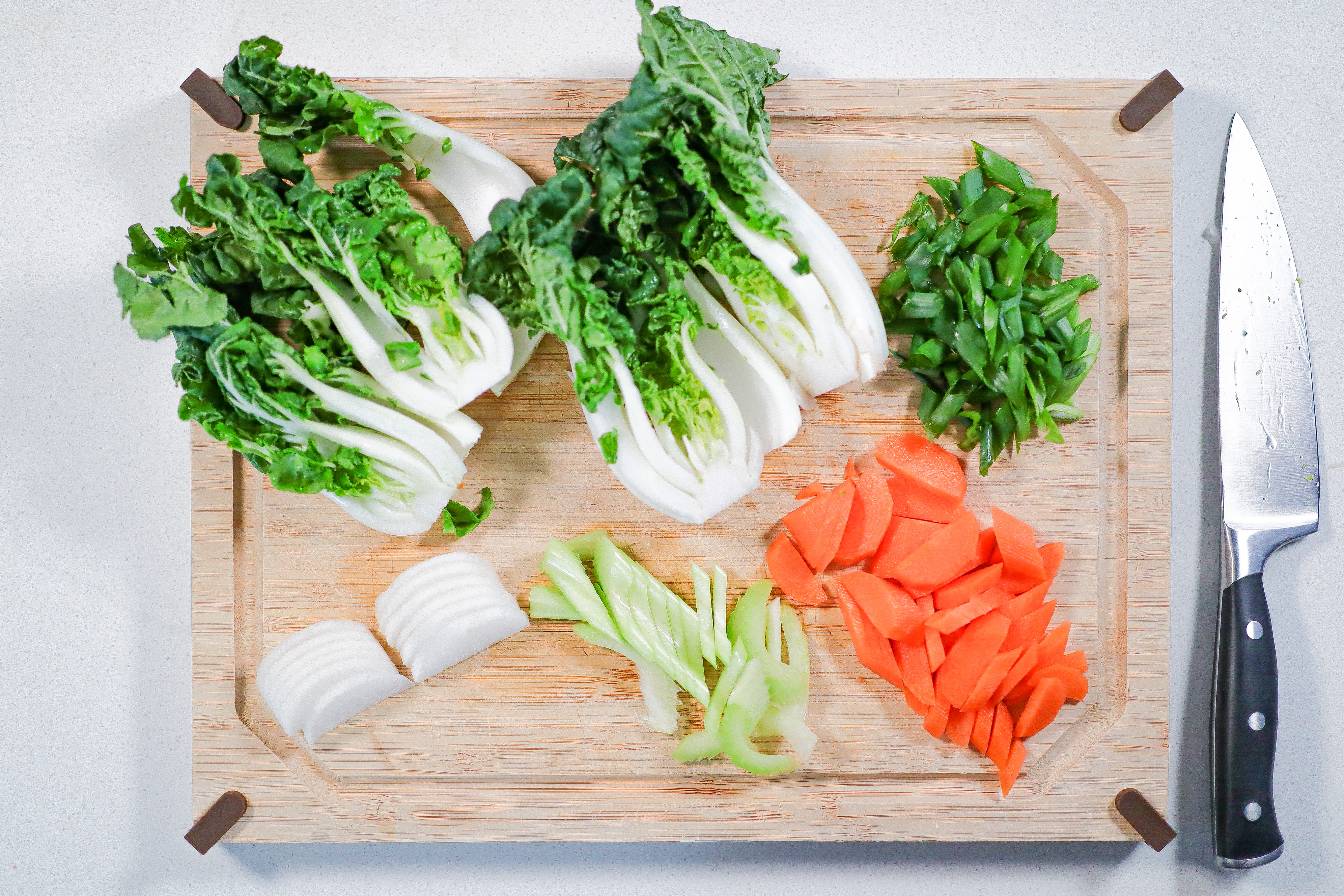 Chopped vegetables on a wood cutting board.