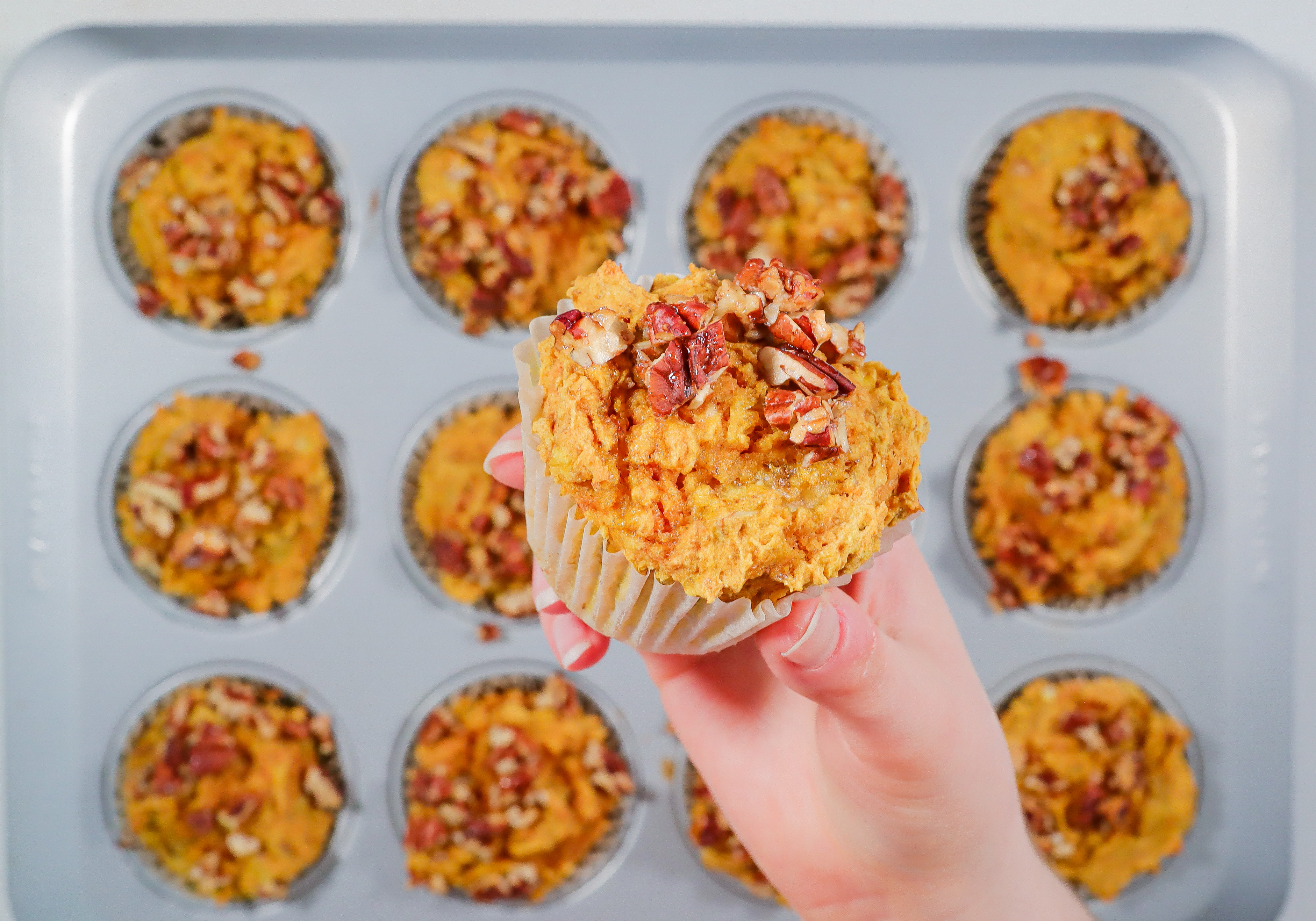 Hand holding a muffin.