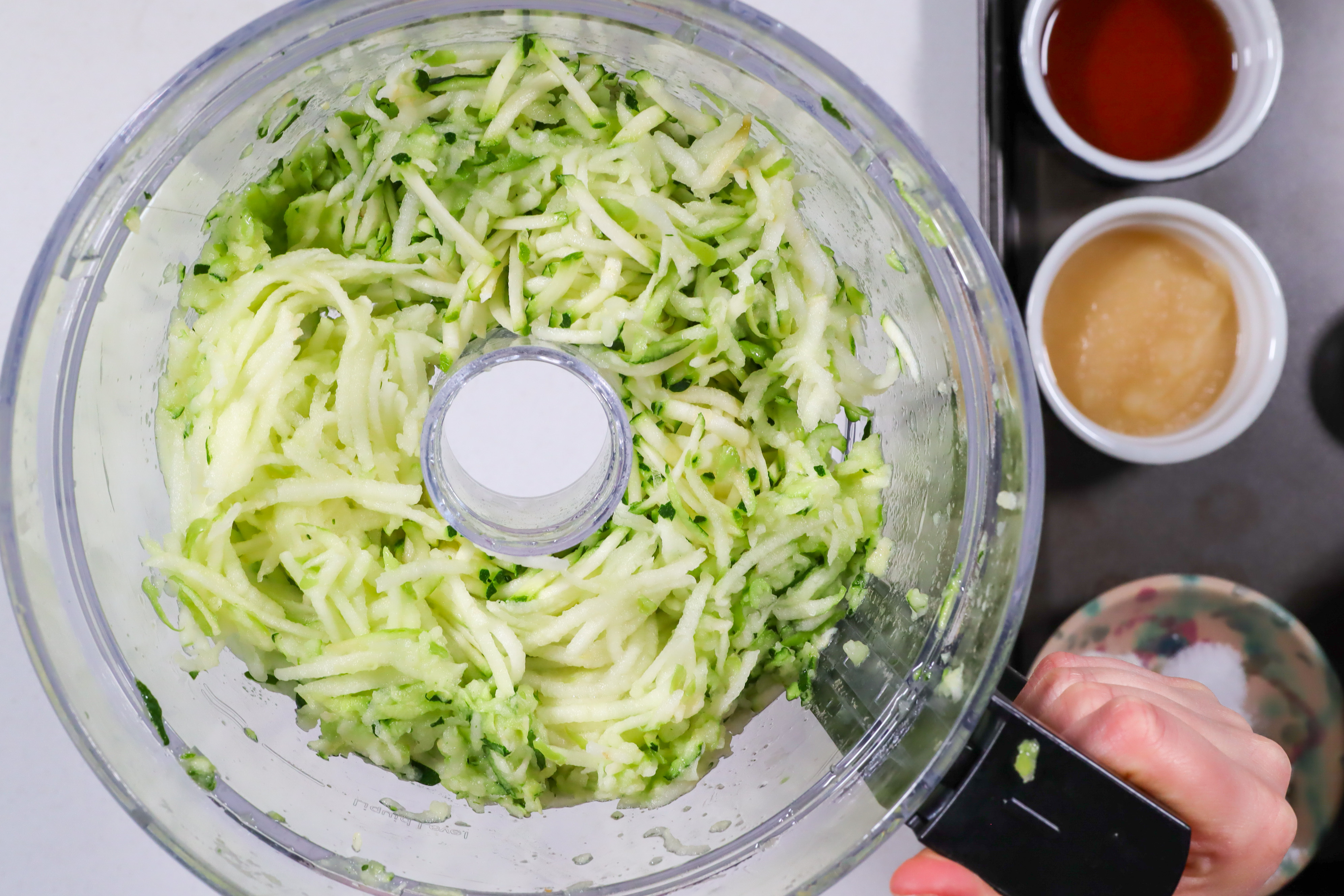 Bowl of shredded zucchini and apple.