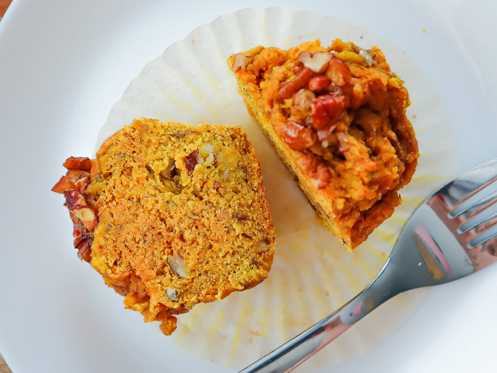 Muffin sliced in half on a plate.