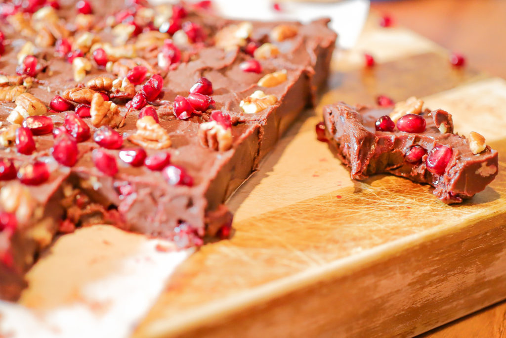 Pomegranate Pecan Fudge sliced on a cutting board.