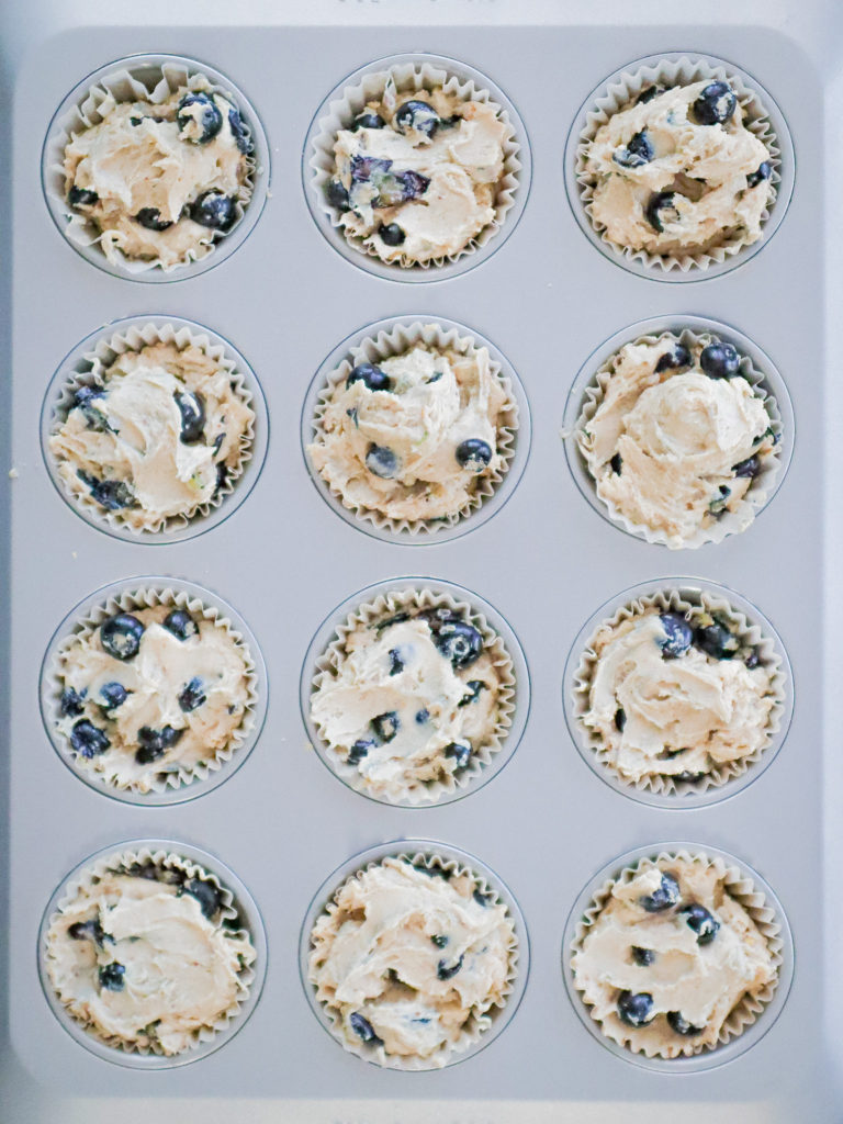 close up of unbaked muffins in a tin