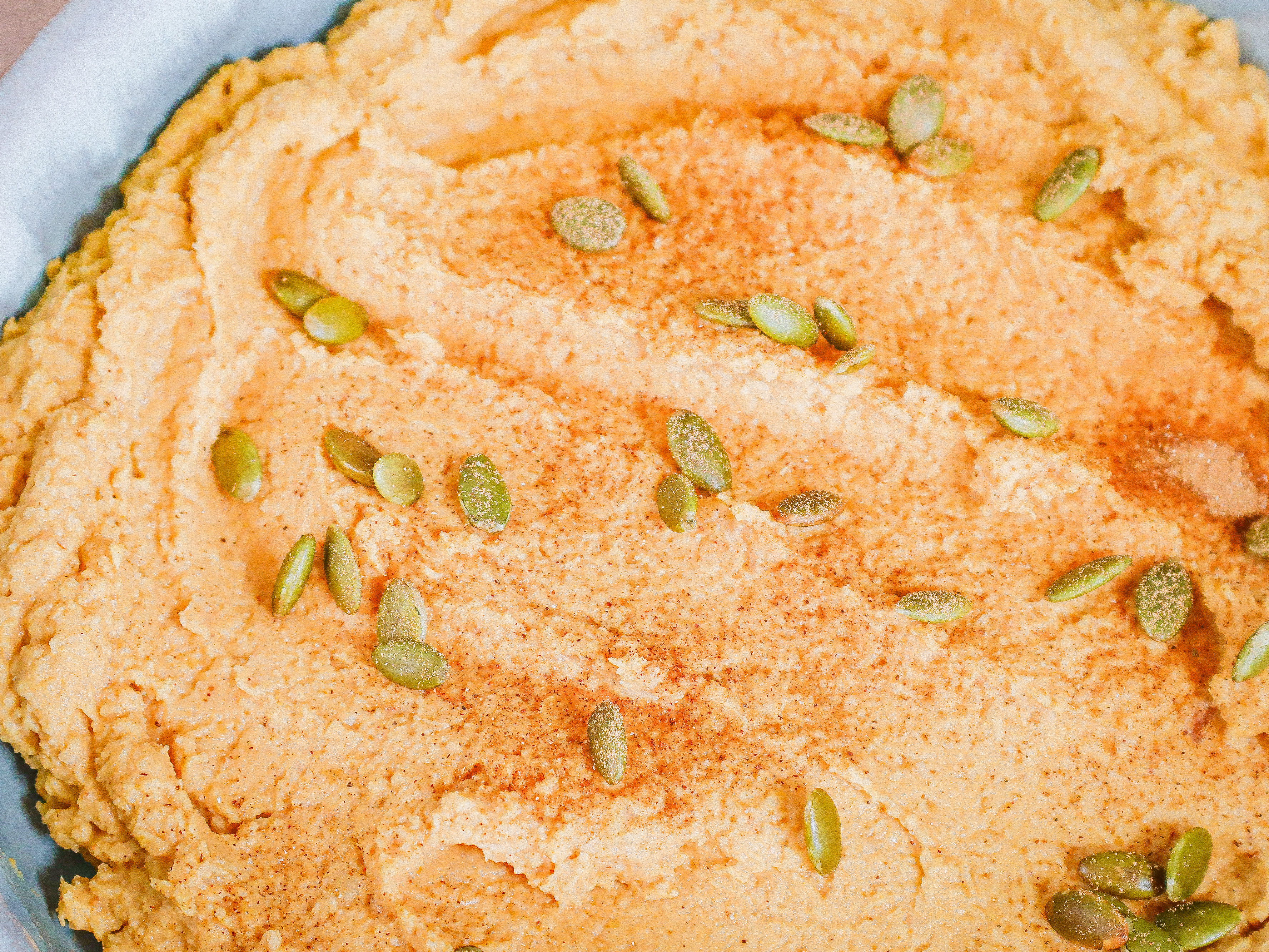 close up photo of bowl of pumpkin spice hummus